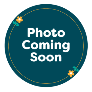 Dark teal circle with the words “Photo Coming Soon” in bold white text, decorated with small yellow flowers and green leaves in two corners.